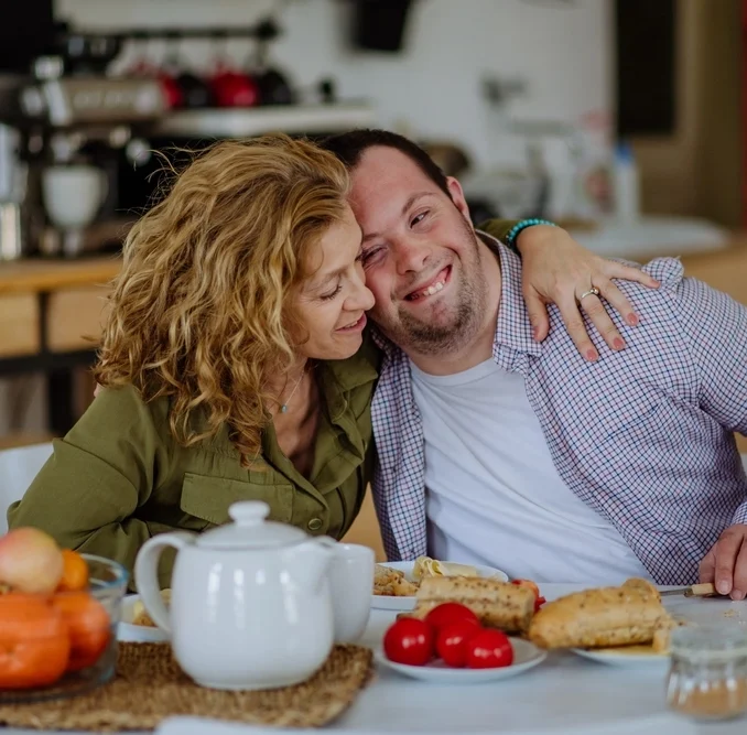 Disabled man hugging mum