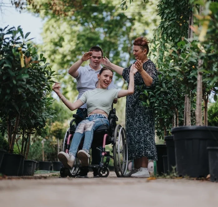Two disabled friends with carers