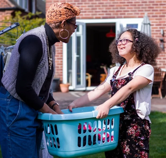 Support worker helping disabled woman with washing