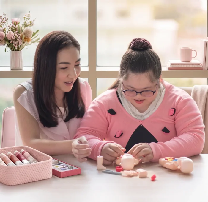 Nurse giving development training to autistic girl